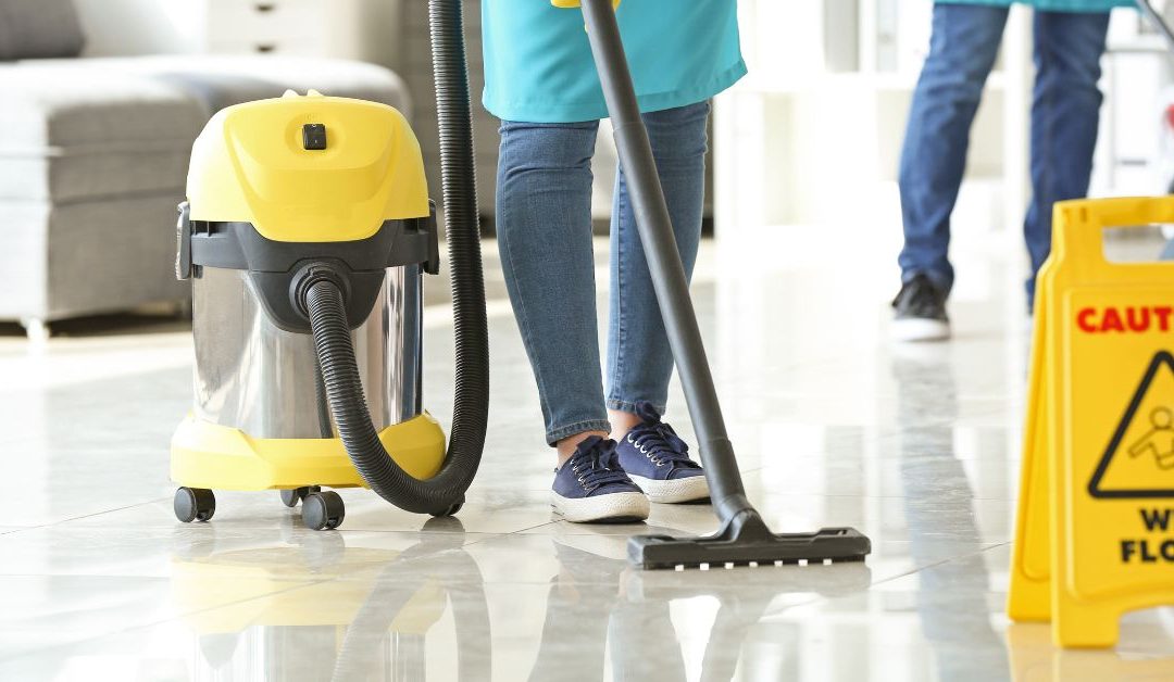 Professional commercial cleaners from Genex Cleaning disinfecting an office workspace in Ann Arbor