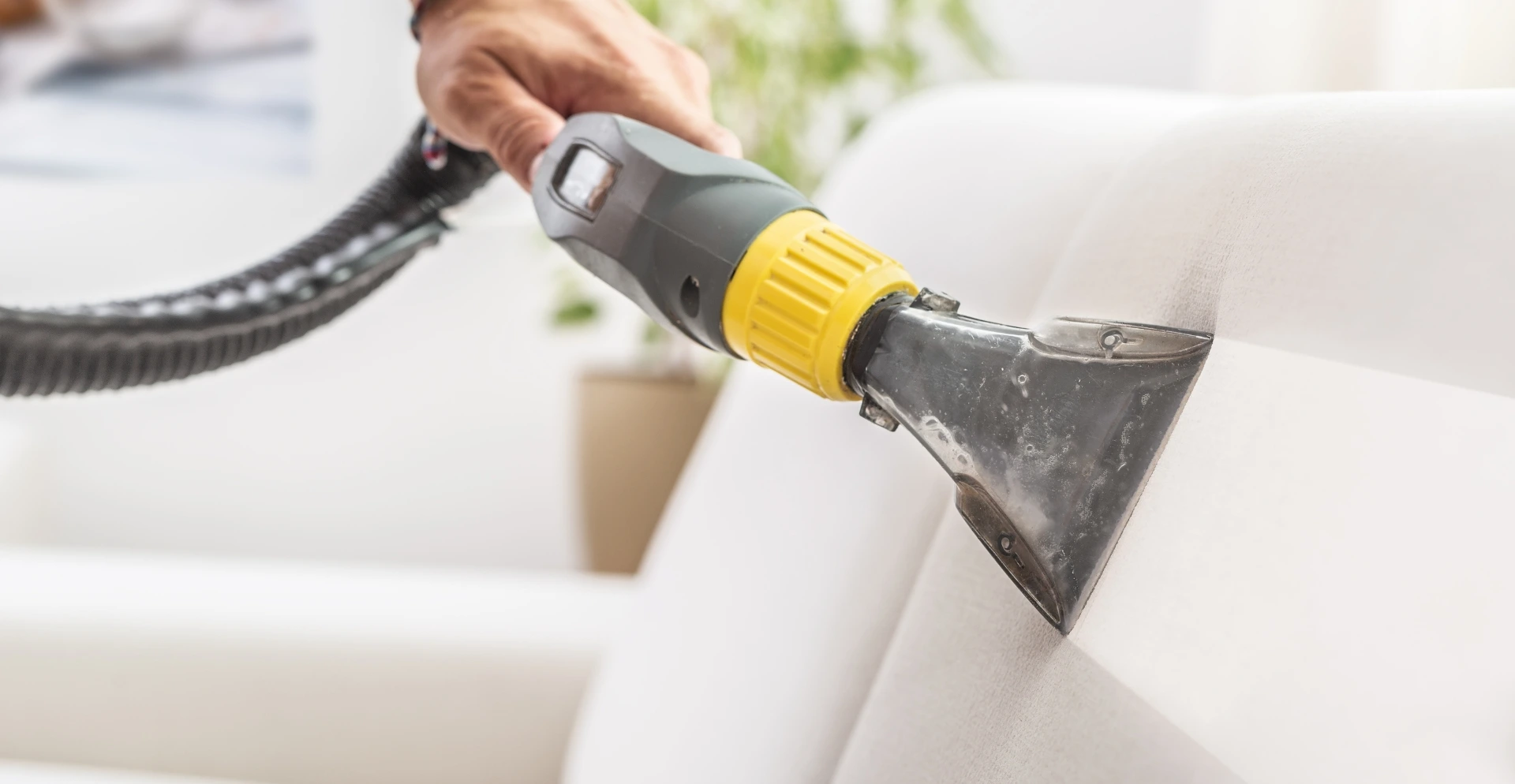 Cleaning technician performing a detailed deep clean of an office space, focusing on hard-to-reach areas and corners